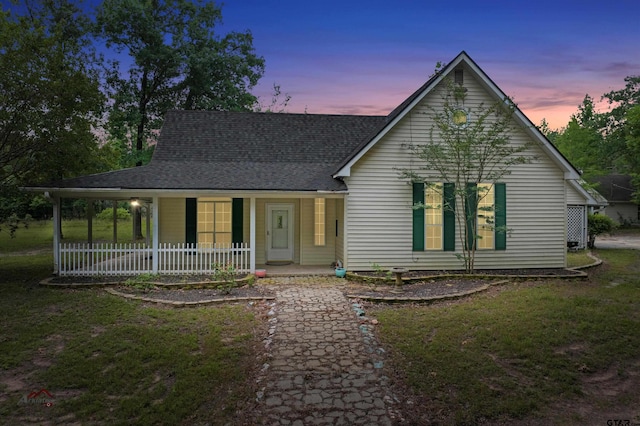 view of front facade featuring a porch and a lawn