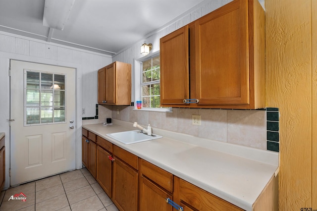 kitchen featuring light tile patterned floors and sink