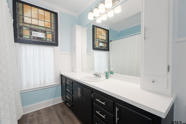 bathroom with vanity, wood-type flooring, and crown molding