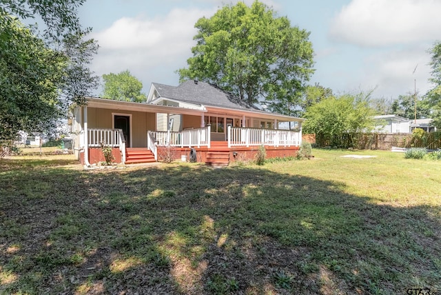 back of house with a yard and a porch