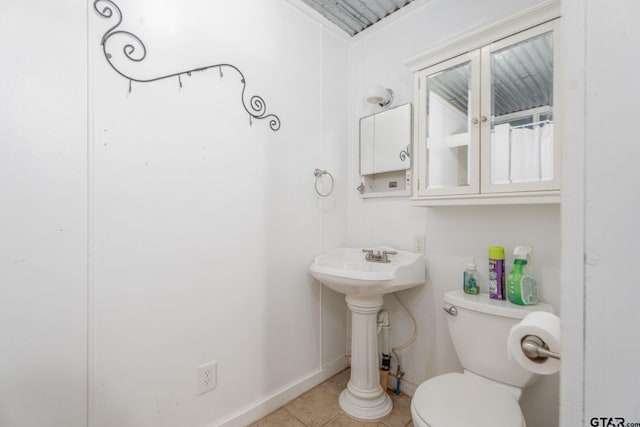 bathroom with sink, tile patterned floors, and toilet