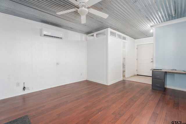 empty room featuring ceiling fan, a wall mounted AC, and hardwood / wood-style flooring