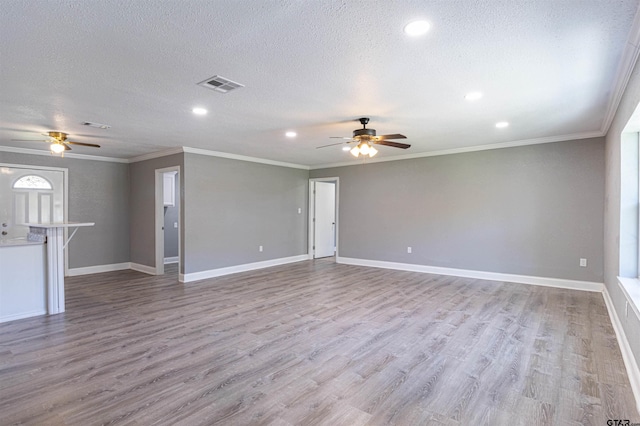 unfurnished living room featuring a textured ceiling, crown molding, and light hardwood / wood-style flooring