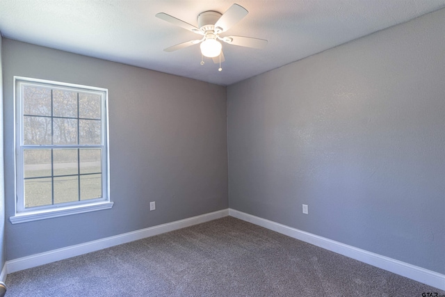 empty room with carpet flooring and ceiling fan