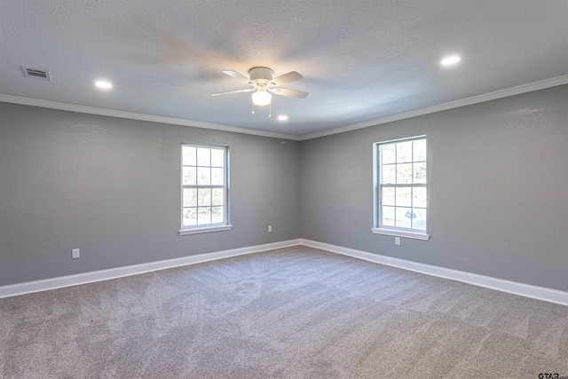 carpeted empty room featuring a textured ceiling, plenty of natural light, ceiling fan, and crown molding