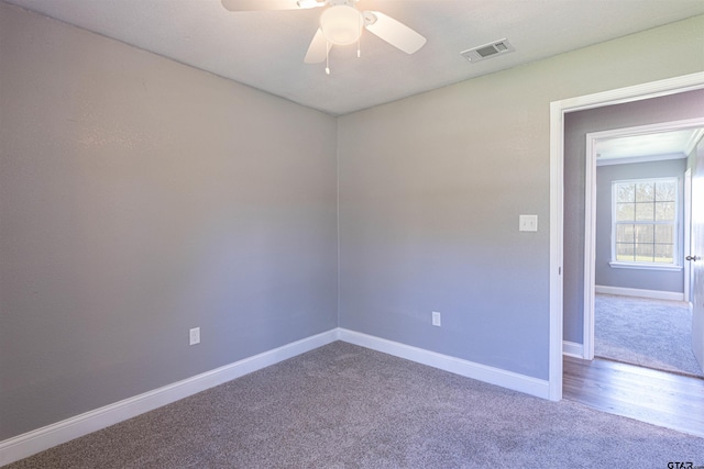 empty room featuring hardwood / wood-style flooring and ceiling fan