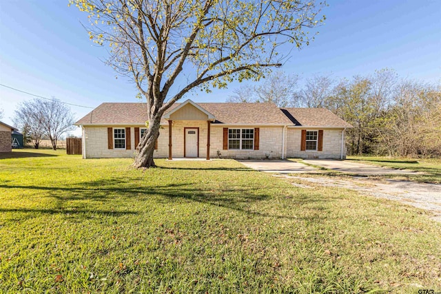 ranch-style home with a front lawn