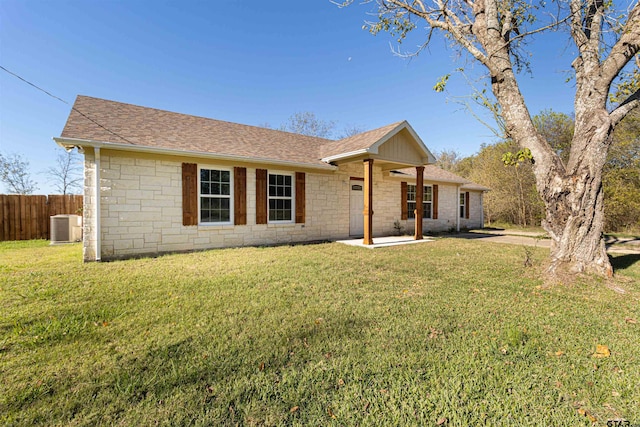 single story home featuring central AC unit and a front yard