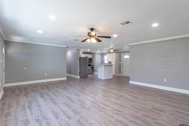 unfurnished living room featuring a textured ceiling, light wood-type flooring, ceiling fan, and crown molding