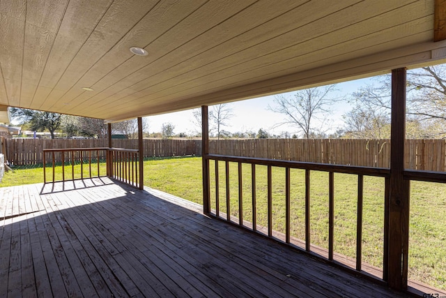 wooden terrace featuring a lawn