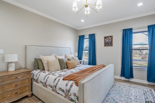 bedroom featuring ornamental molding, a chandelier, and light hardwood / wood-style floors