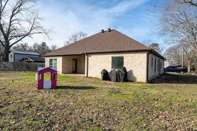 rear view of property featuring a yard