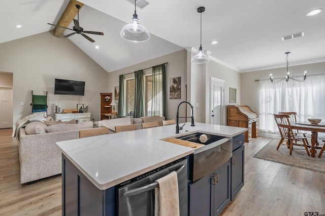 kitchen featuring decorative light fixtures, light wood-type flooring, stainless steel dishwasher, and a center island with sink