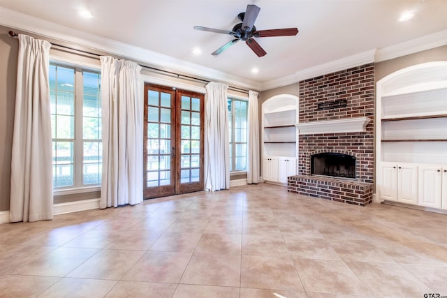 unfurnished living room featuring french doors, a healthy amount of sunlight, a fireplace, and built in features