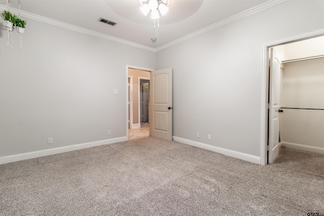 unfurnished bedroom with crown molding, carpet floors, and ceiling fan