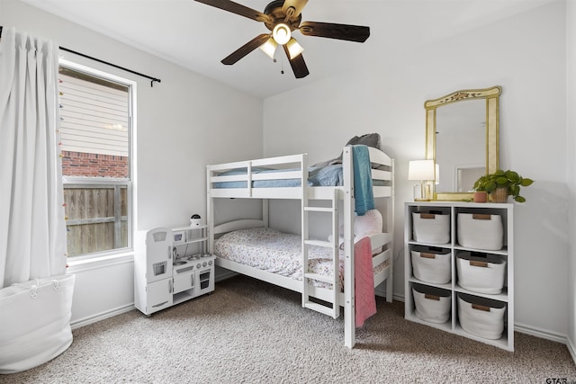 bedroom featuring baseboards, a ceiling fan, and carpet
