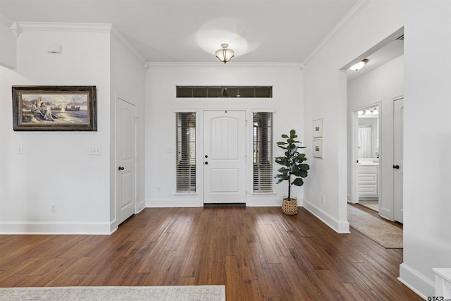 foyer entrance featuring baseboards, dark wood-style floors, and ornamental molding