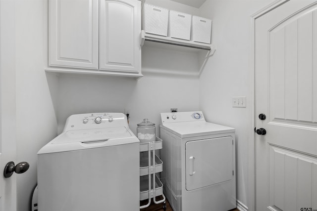 laundry room with cabinet space and washing machine and dryer