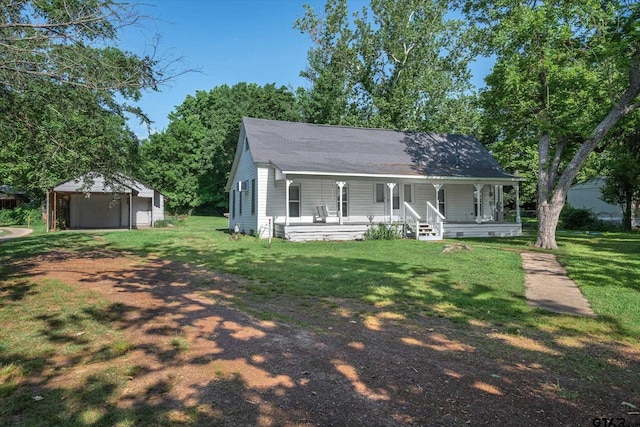 1498 Fm 279, Ben Wheeler, TX 75754 - view of front of property with a porch, a garage, a front lawn, an outbuilding, and dirt driveway