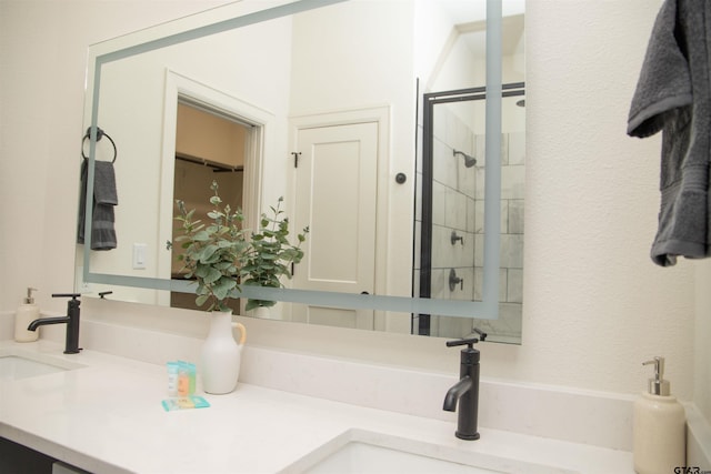 bathroom with vanity and tiled shower