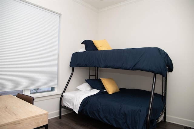 bedroom with dark wood-type flooring and crown molding