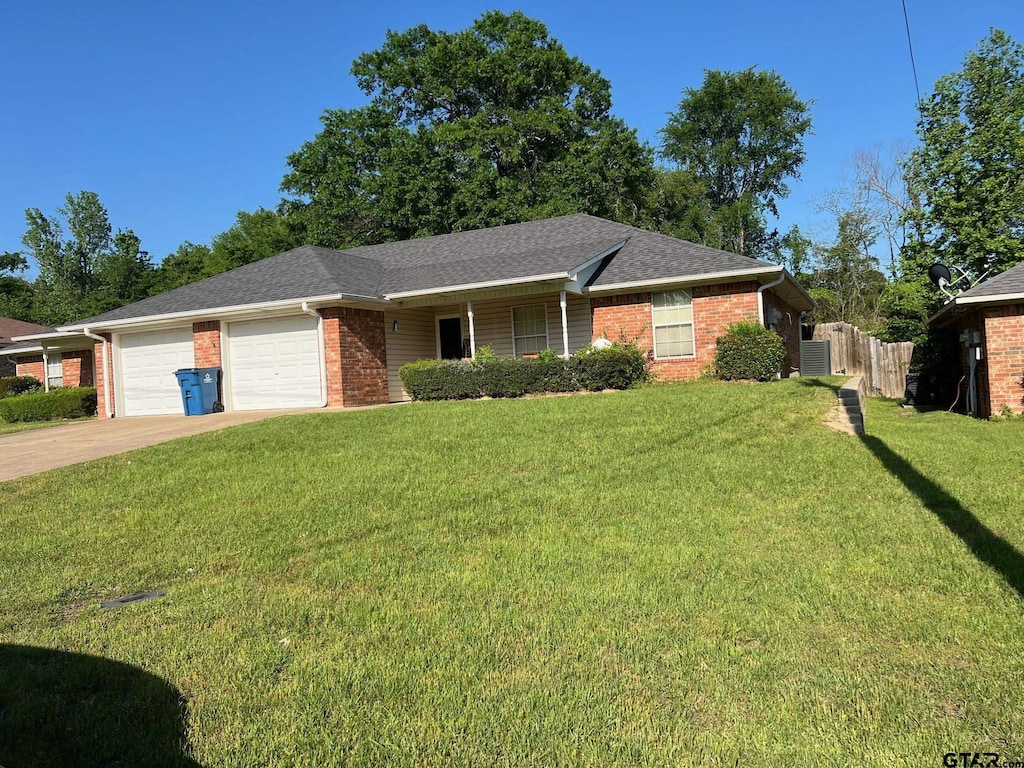 16067 Echo Glen Dr, Tyler, TX 75703 - single story home featuring brick siding, an attached garage, concrete driveway, central AC, and a shingled roof
