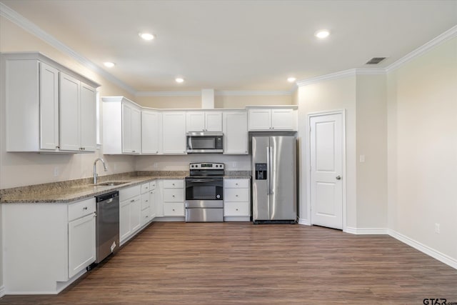 kitchen with light stone countertops, white cabinetry, and stainless steel appliances