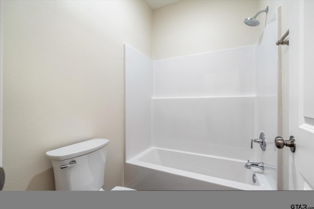 bathroom featuring shower / bath combination and toilet