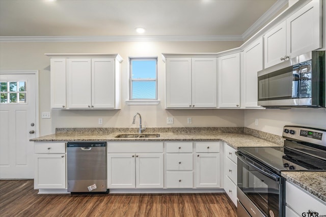 kitchen with white cabinetry, ornamental molding, appliances with stainless steel finishes, and dark wood-type flooring