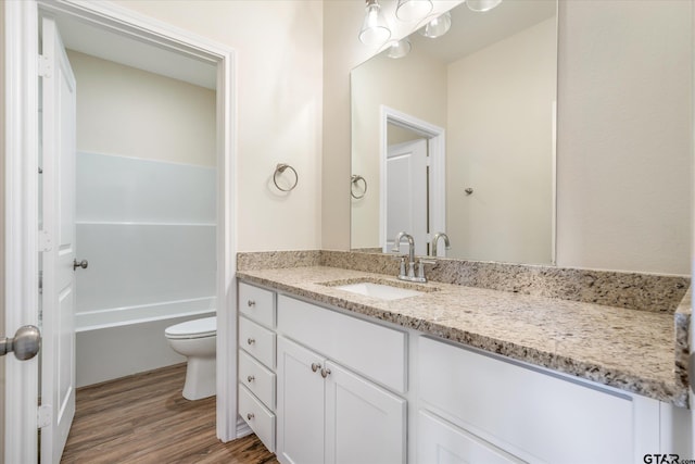 bathroom featuring hardwood / wood-style flooring, vanity, and toilet