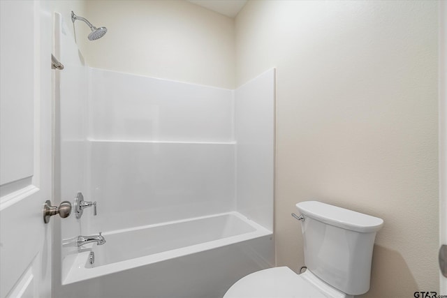 bathroom featuring bathing tub / shower combination and toilet