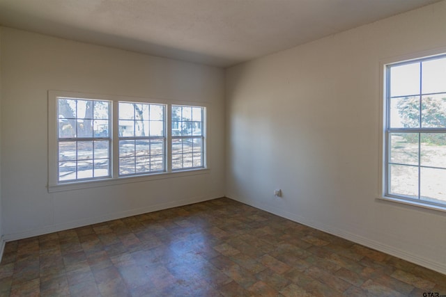 spare room with baseboards