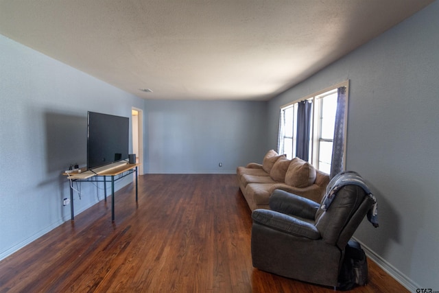 living room with baseboards and wood finished floors