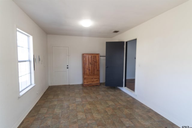 empty room featuring visible vents and baseboards