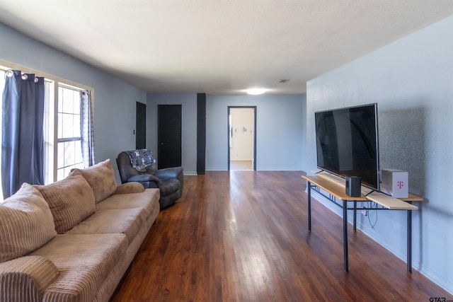 living area featuring baseboards and wood finished floors