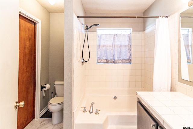 bathroom with toilet, shower / bath combination with curtain, and vanity