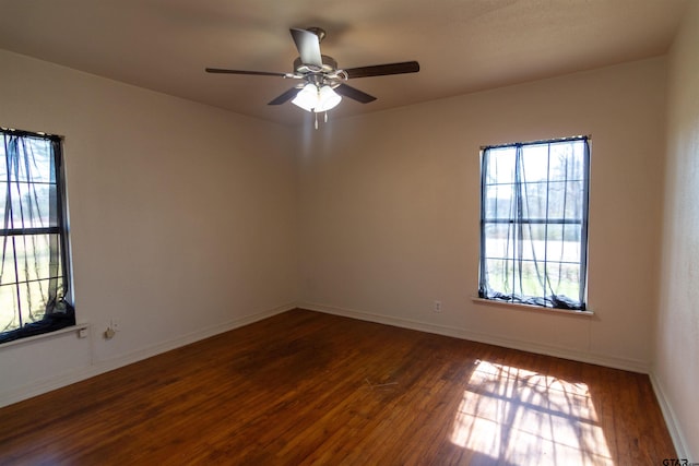 unfurnished room featuring ceiling fan, wood finished floors, and baseboards