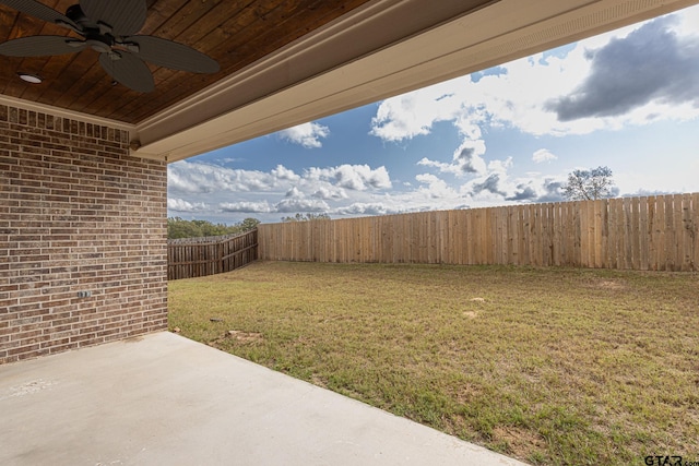 view of yard featuring ceiling fan and a patio area