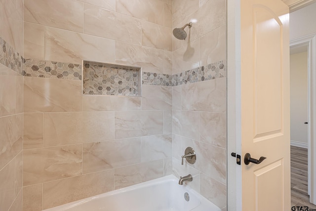 bathroom with tiled shower / bath and hardwood / wood-style flooring