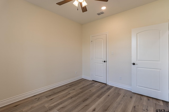 spare room featuring ceiling fan and light hardwood / wood-style flooring