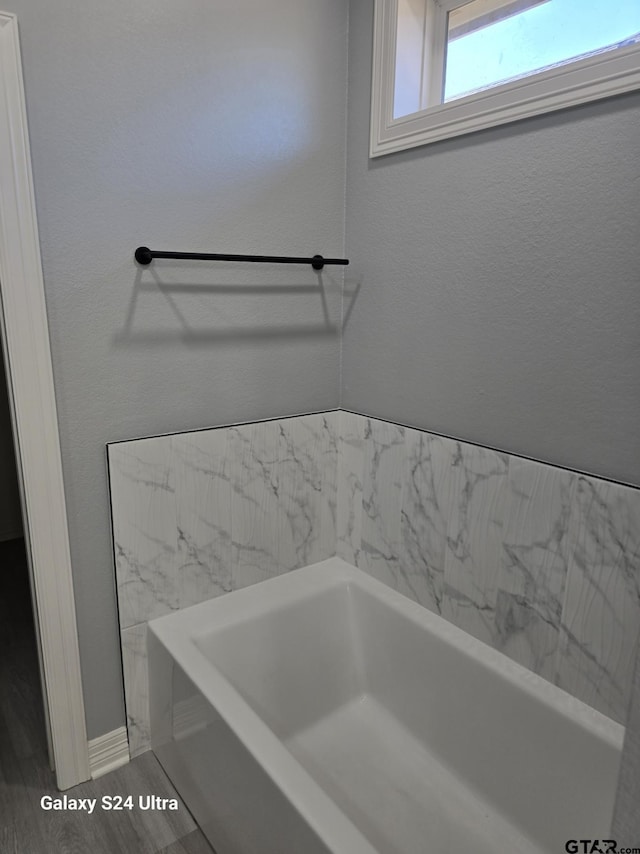 bathroom featuring a bathtub and hardwood / wood-style flooring