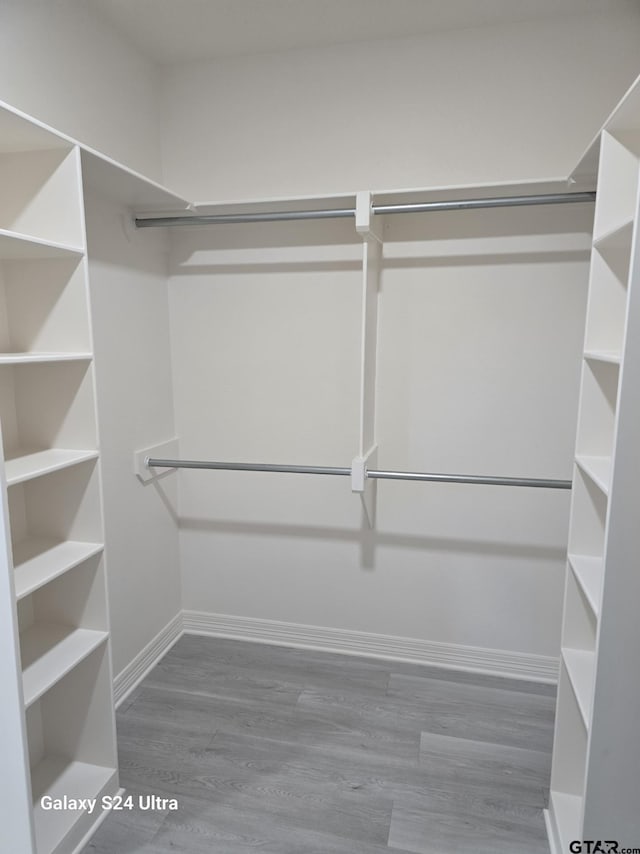 walk in closet featuring hardwood / wood-style flooring