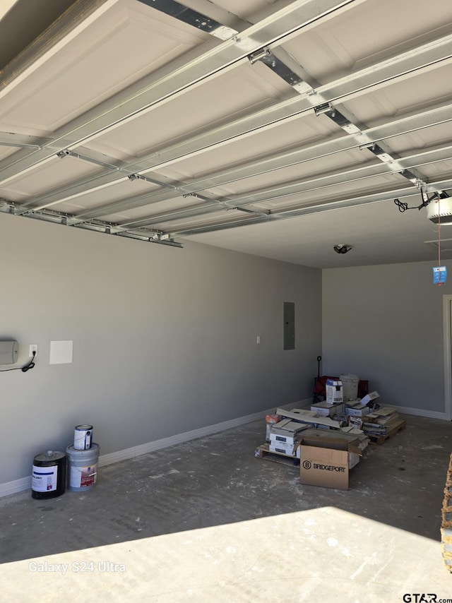 garage with a garage door opener and electric panel