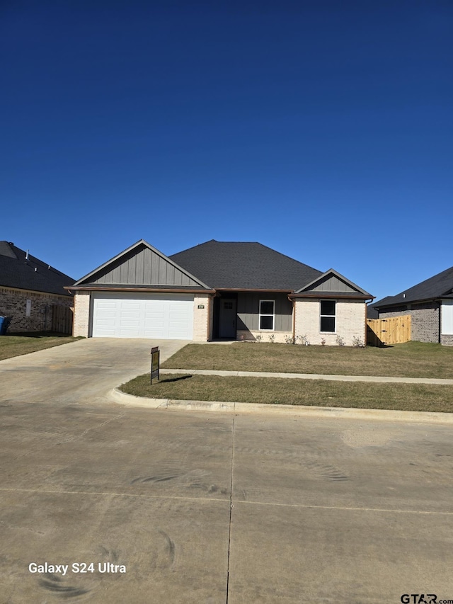 view of front of home with a garage and a front yard