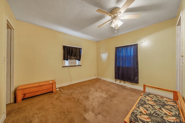 carpeted bedroom with cooling unit, a textured ceiling, and ceiling fan