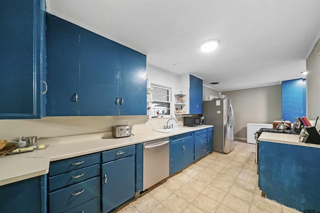 kitchen with sink, blue cabinets, and appliances with stainless steel finishes