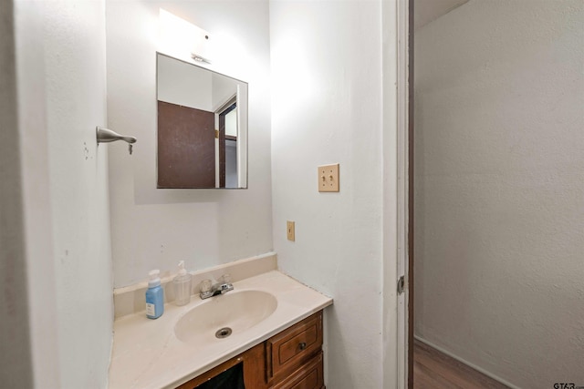 bathroom with vanity and wood-type flooring