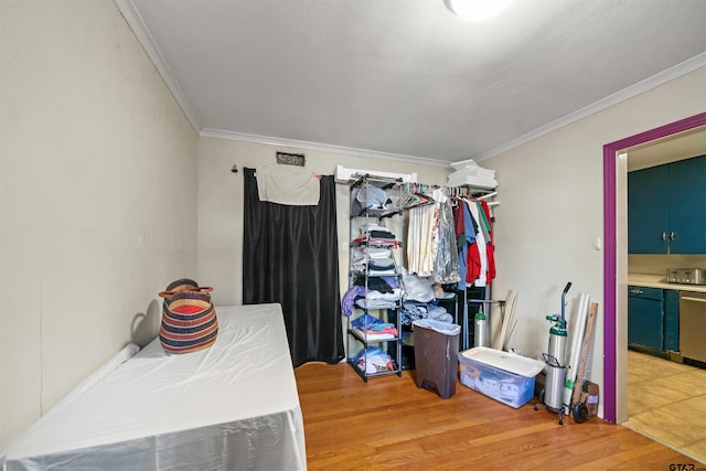 bedroom featuring ornamental molding and light wood-type flooring