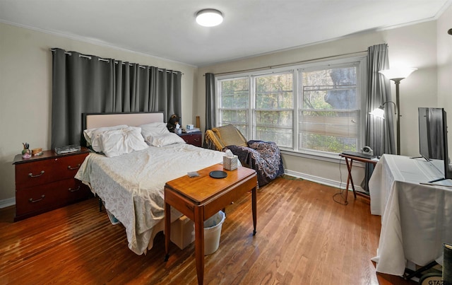 bedroom featuring hardwood / wood-style floors and ornamental molding