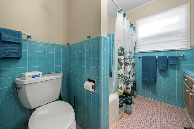 full bathroom with shower / bath combo, tile patterned floors, toilet, ornamental molding, and tile walls